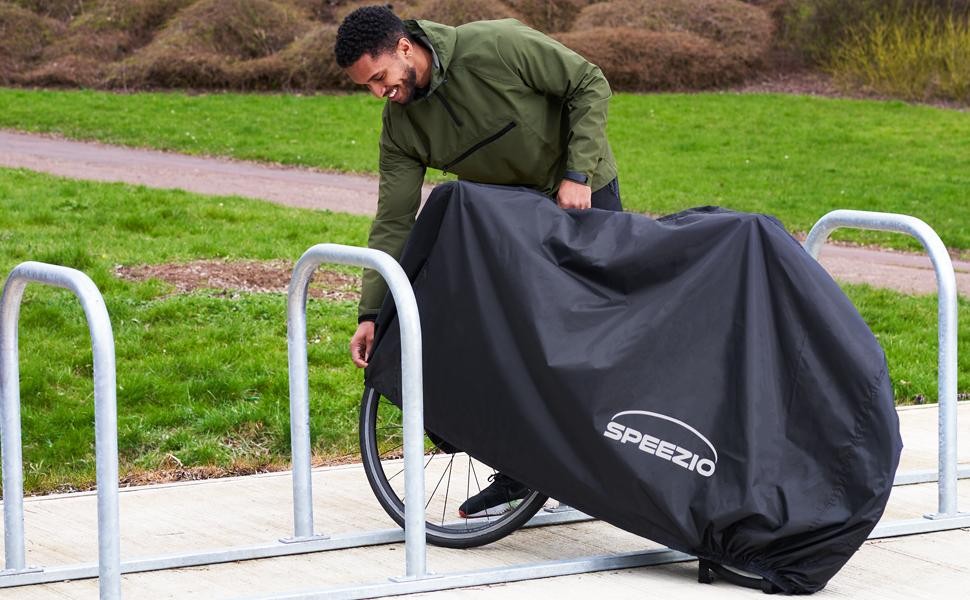 A man covering his bike